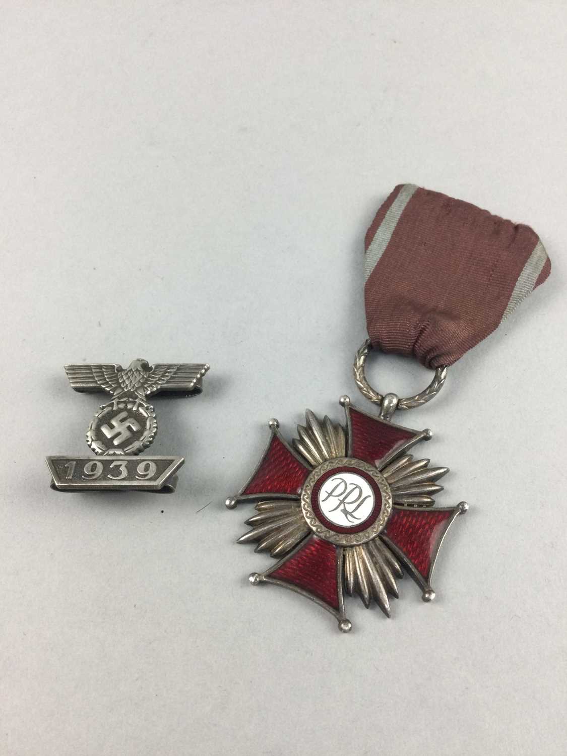 Lot 93 - A POLISH ORDER OF MERIT MEDAL ALONG WITH A THIRD REICH BADGE