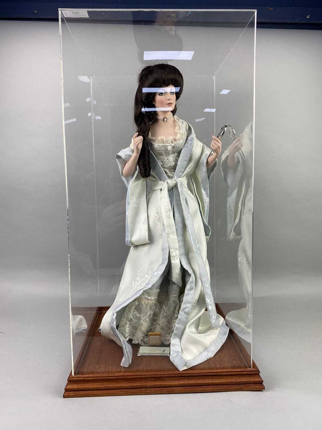 Lot 594 - A PORCELAIN DOLL