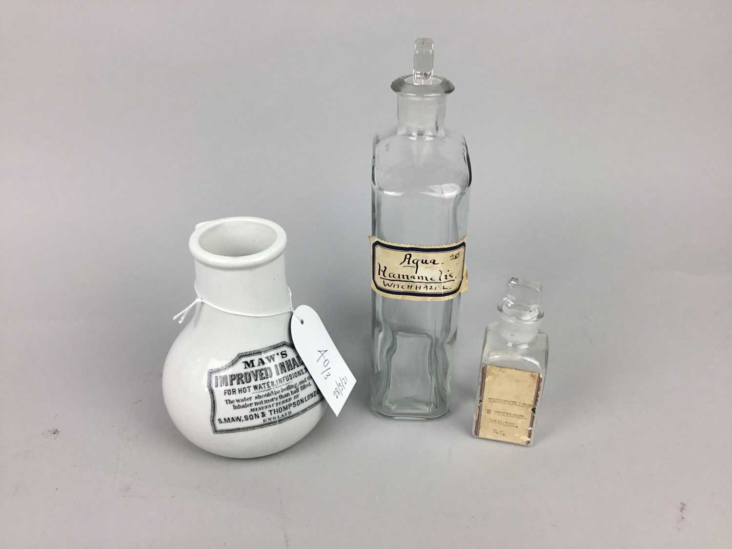 Lot 40 - A GLASS PHARMACEUTICAL BOTTLE AND TWO OTHERS