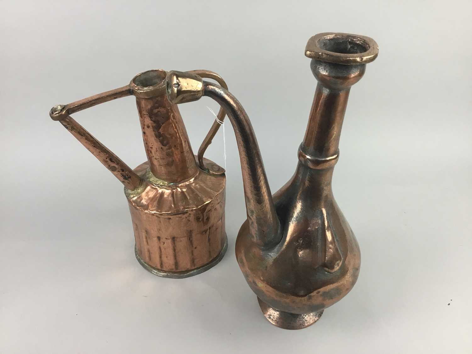 Lot 277 - A GROUP OF THREE MIDDLE EASTERN COPPER JUGS