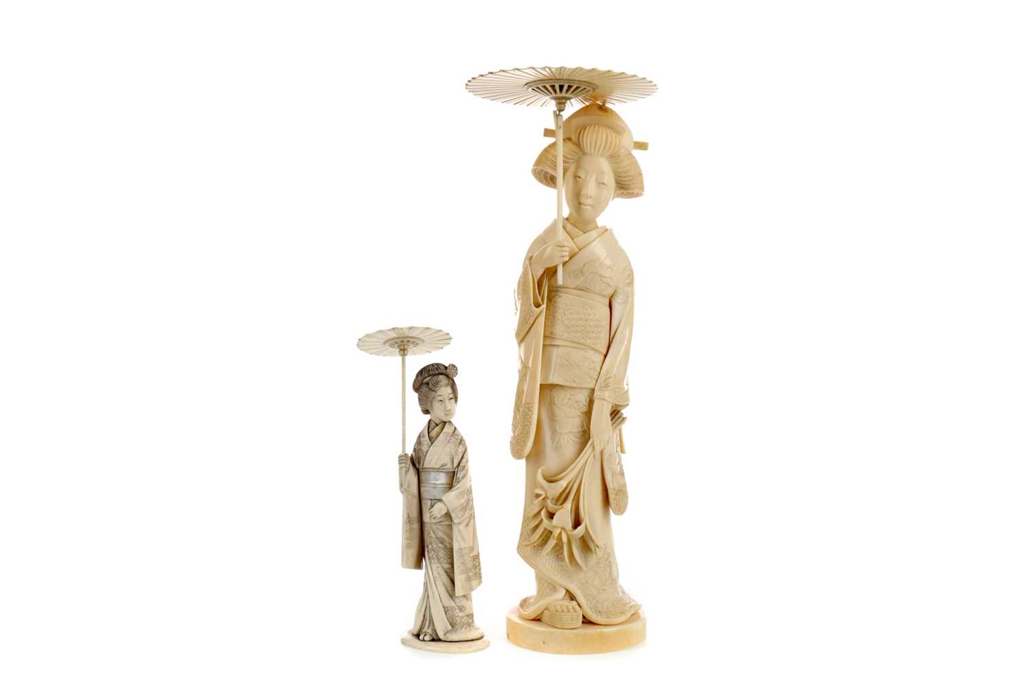 Lot 885 - AN EARLY 20TH CENTURY JAPANESE CARVING OF A GEISHA AND ANOTHER