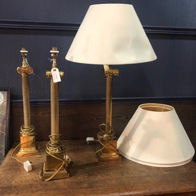 Lot 600A - A LOT OF THREE BRASS CORINTHIAN TABLE LAMPS WITH SHADES