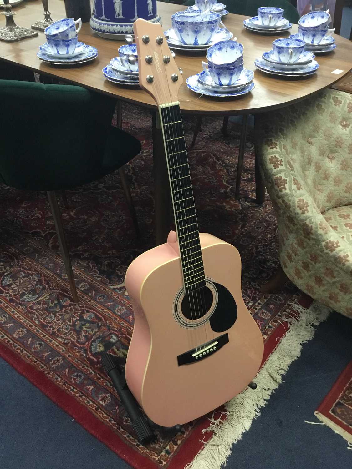 Lot 40 - A CHILD'S PINK ACOUSTIC GUITAR ON STAND