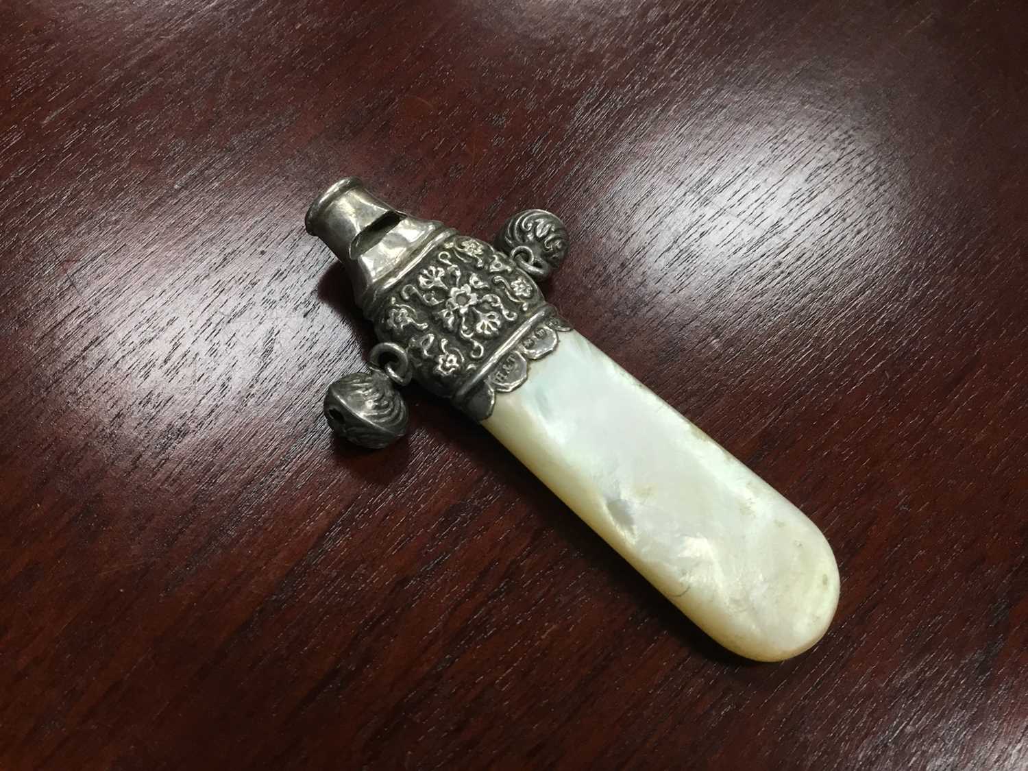 Lot 79 - A SILVER AND MOTHER OF PEARL BABY RATTLE