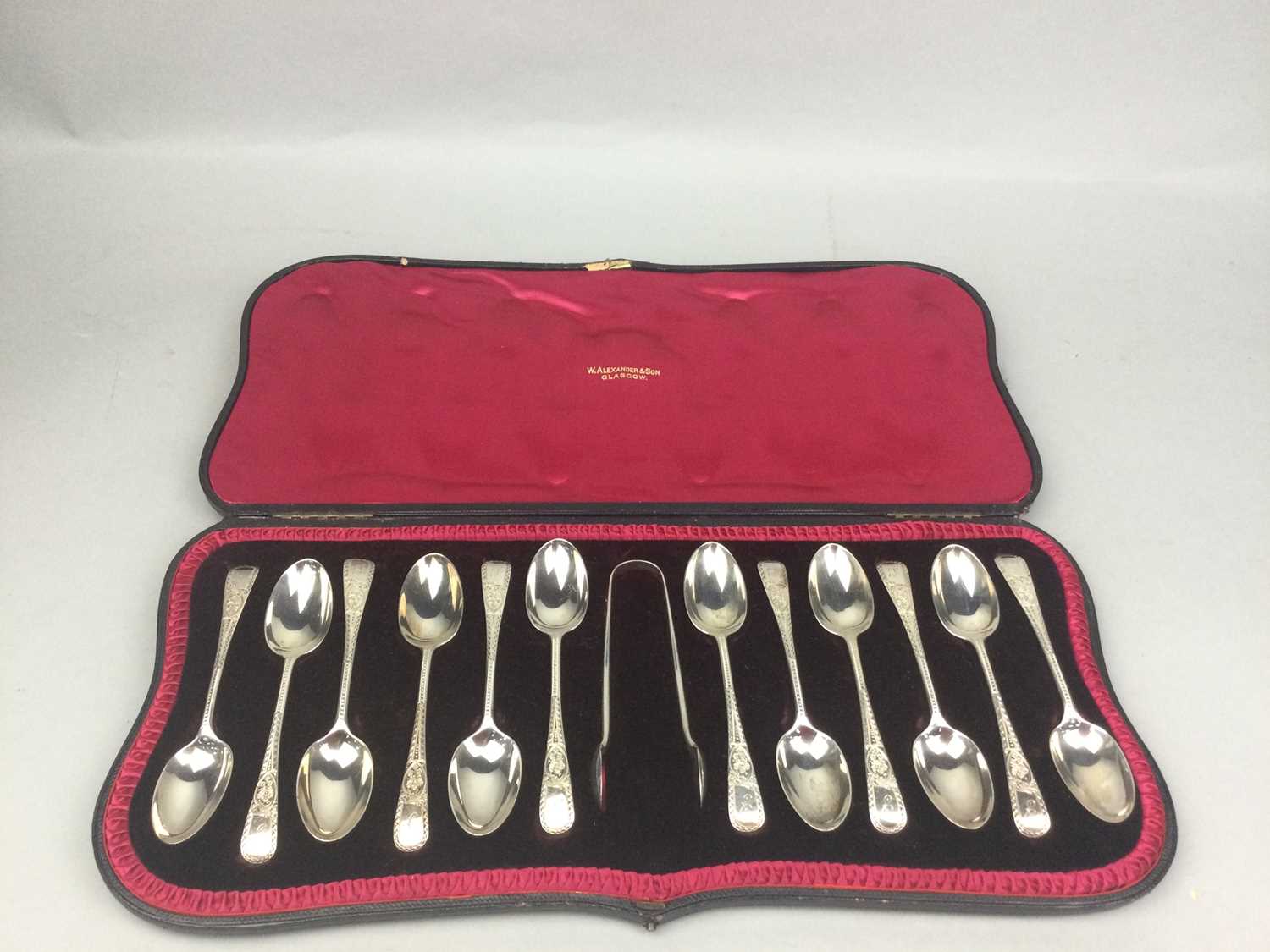 Lot 62 - A CASED SET OF TWELVE SILVER SPOONS AND TONGS