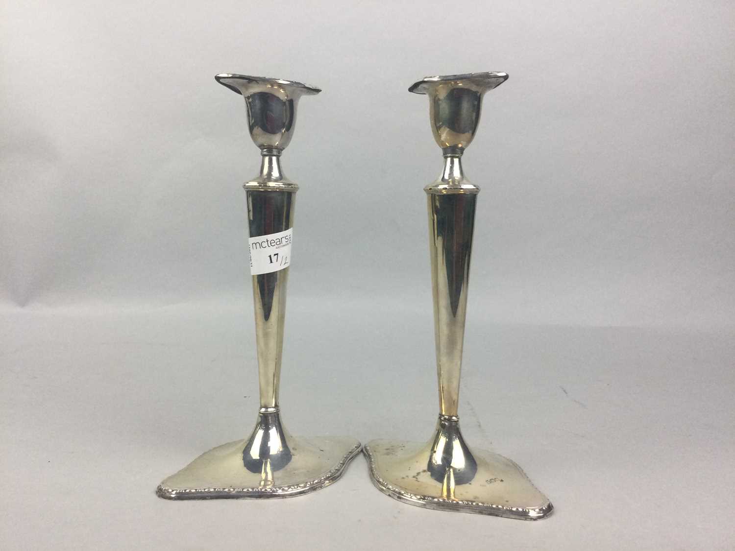 Lot 17 - A PAIR OF SILVER CANDLESTICKS