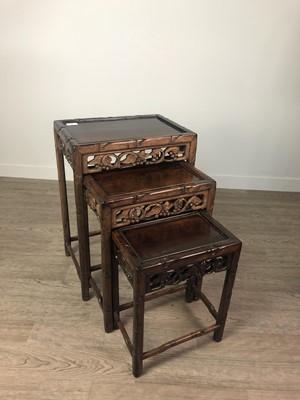 Lot 907 - A 20TH CENTURY CHINESE HARDWOOD NEST OF THREE TABLES