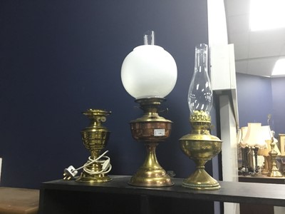 Lot 138 - A COPPER AND BRASS OIL LAMP, A BRASS OIL LAMP AND ANOTHER