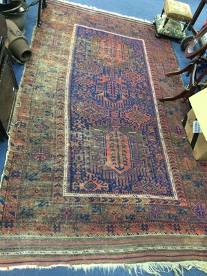 Lot 234 - A PERSIAN FRINGED AND BORDERED RUG