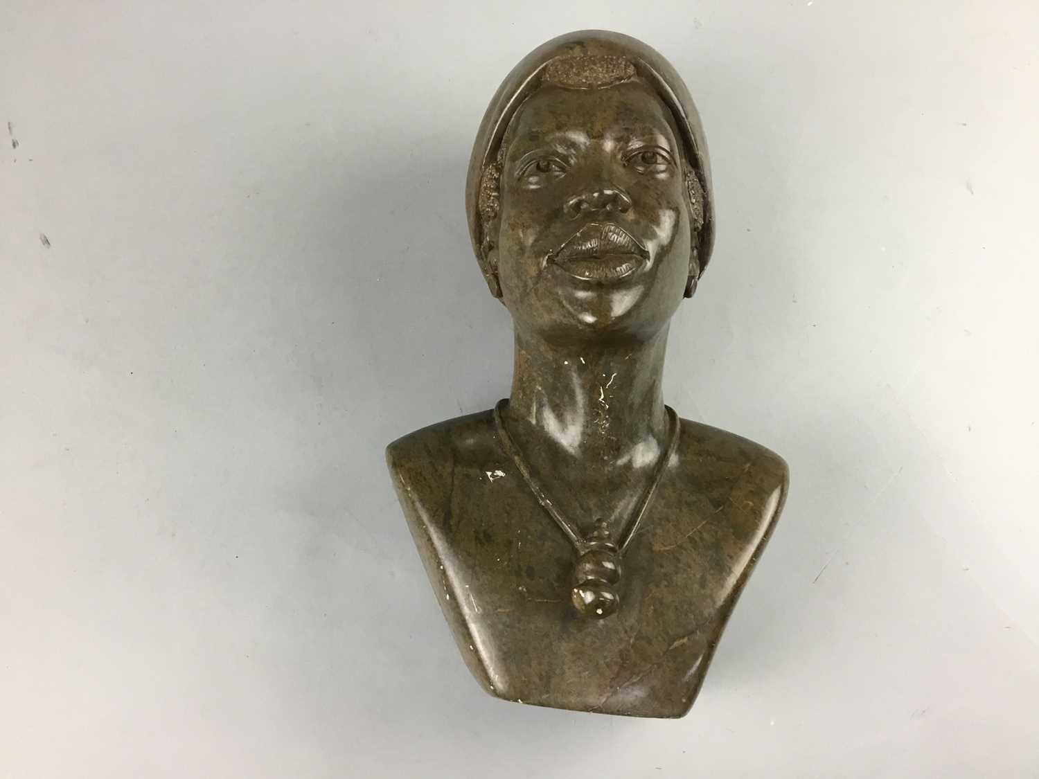 Lot 40 - AN AFRICAN CARVED HARDSTONE BUST OF A WOMAN