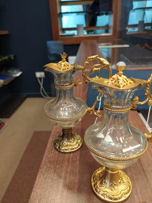 Lot 1729 - A PAIR OF LATE 19TH CENTURY GLASS AND GILTMETAL EWERS