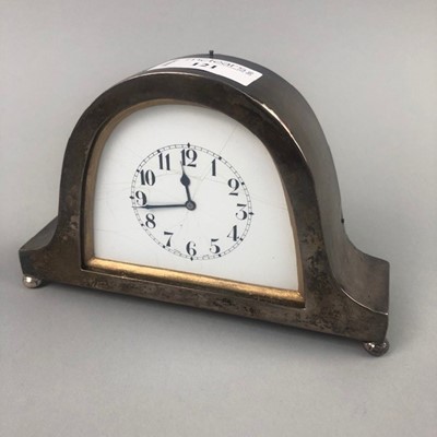 Lot 121 - A SMALL SILVER CASED BEDROOM CLOCK