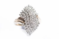 Lot 79 - DIAMOND CLUSTER RING the curving hexagonal...