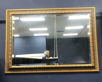 Lot 404 - A GILT FRAMED RECTANGULAR WALL MIRROR