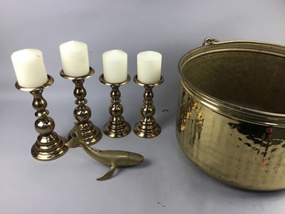 Lot 463 - A LOT OF FOUR BRASS CANDLESTICKS AND A LARGE BRASS POT