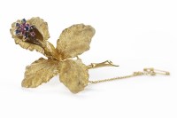 Lot 106 - SAPPHIRE AND RUBY SET GOLD FLORAL BROOCH in...