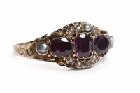 Lot 135 - VICTORIAN GARNET AND SPLIT PEARL RING set with...