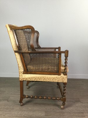 Lot 1748 - AN EARLY 20TH CENTURY CANE PANELLED OAK WINGBACK ARMCHAIR