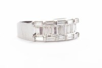 Lot 199 - DIAMOND RING with a central row of channel set...