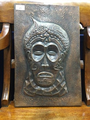 Lot 475 - AN EMBOSSED COPPER PANEL DEPICTING A TRIBAL HEAD