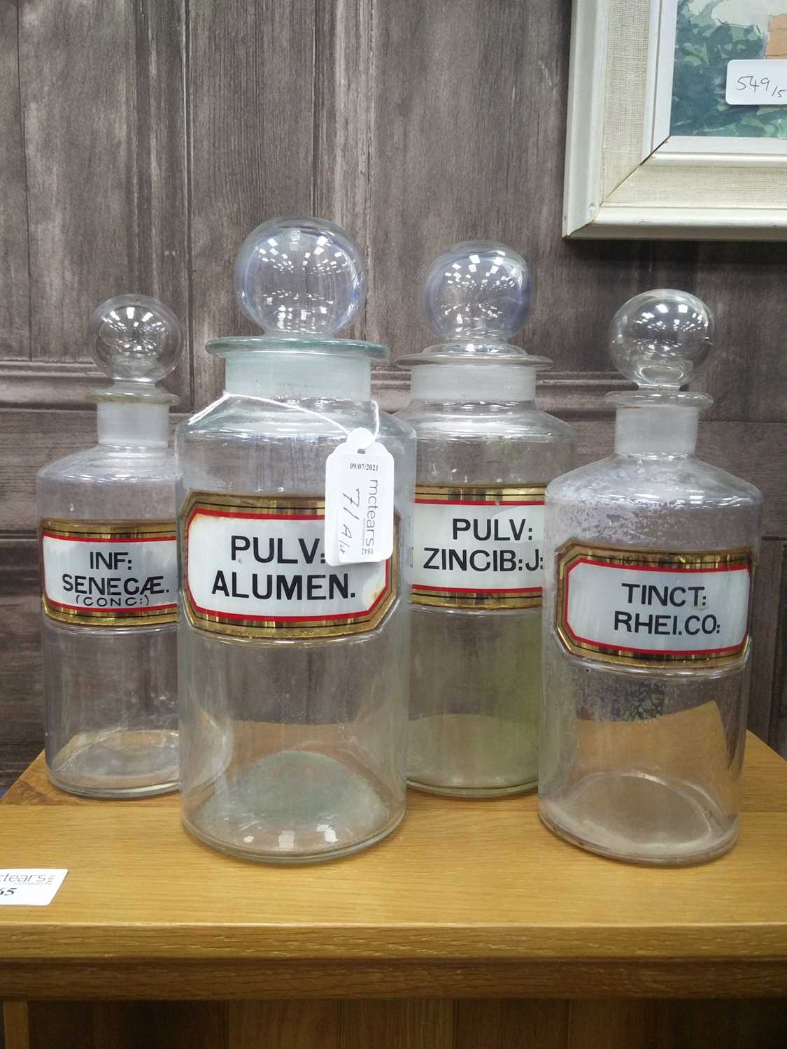 Lot 71 - A GROUP OF FOUR GLASS PHARMACEUTICAL JARS WITH STOPPERS
