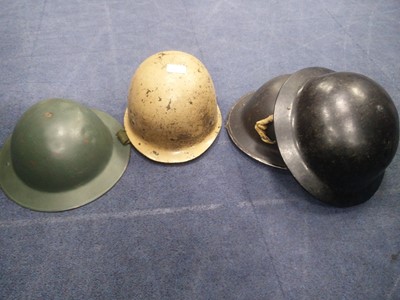 Lot 117 - A GROUP OF FOUR WWII MILITARY HELMETS