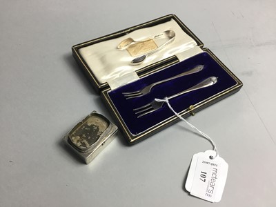 Lot 107 - A CASED PAIR OF SILVER PICKLE FORKS, ALONG WITH TONGS AND A PILL BOX