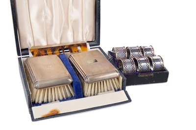 Lot 425 - AN ELIZABETH II SILVER BACKED BRUSH SET, ALONG WITH A SET OF NAPKIN RINGS AND TEASPOONS