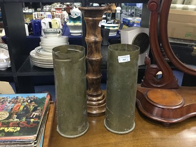 Lot 553 - A CARVED FOLDING OCCASIONAL TABLE, TURNED WOOD CANDLESTICK AND TWO SHELL CASINGS