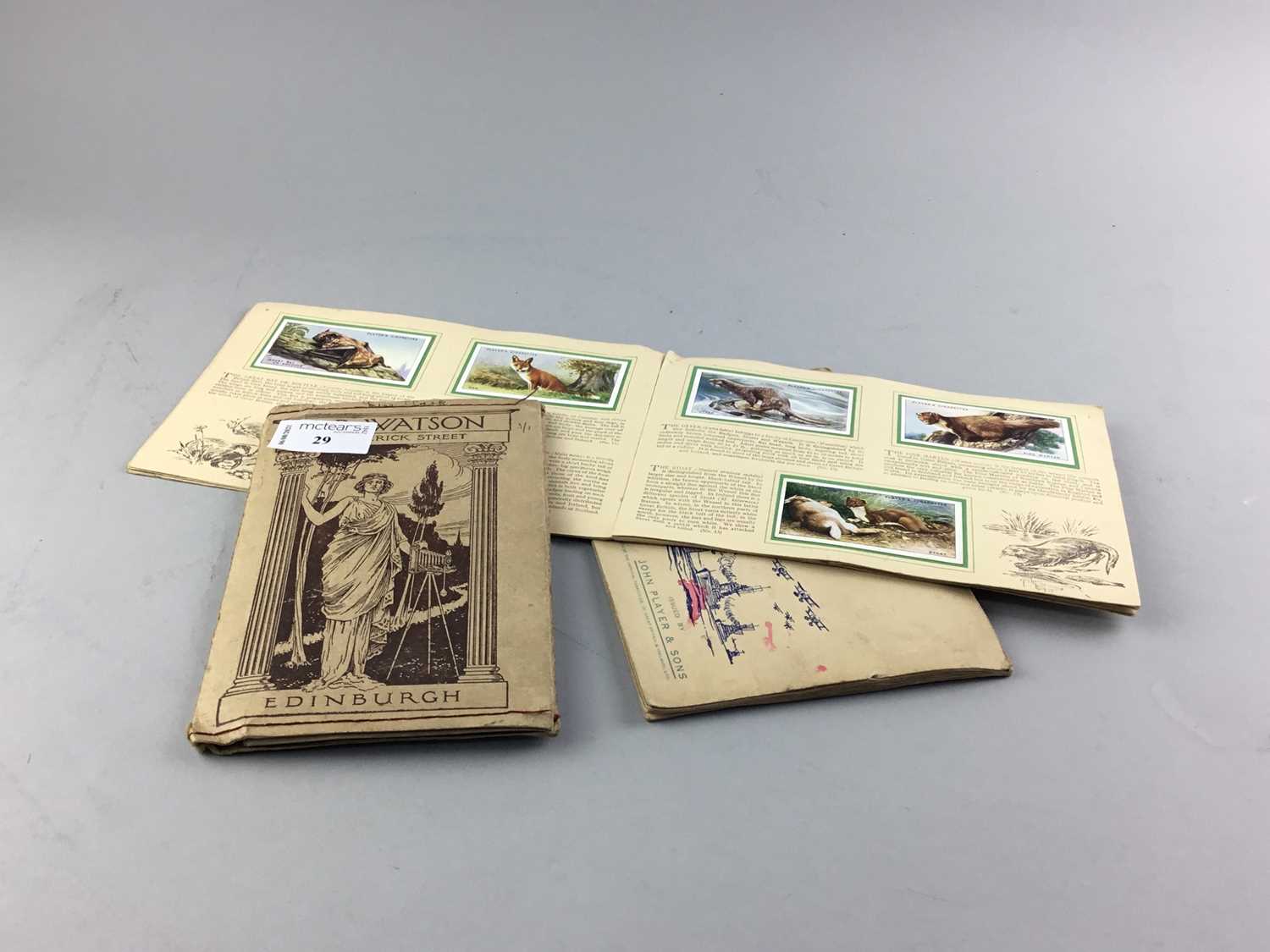 Lot 29 - A LOT OF TWO BOOKS OF CIGARETTE CARDS AND POSTCARDS