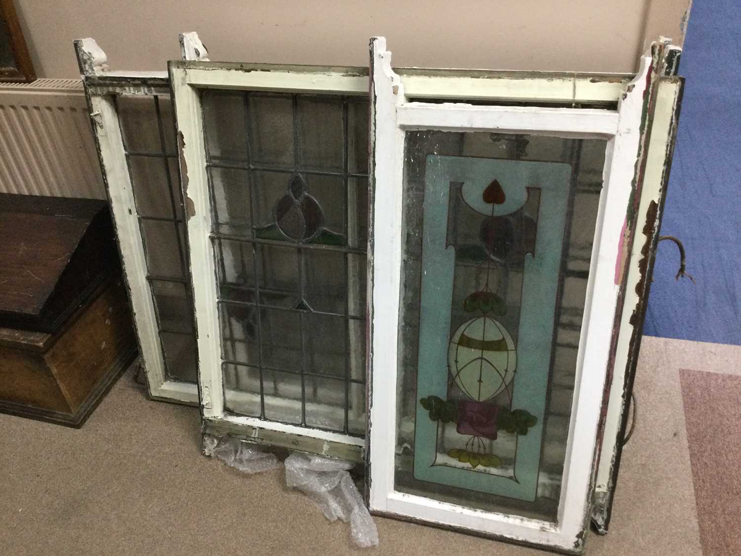 Lot 87 - A SET OF THREE STAINED AND LEADED GLASS PANELS