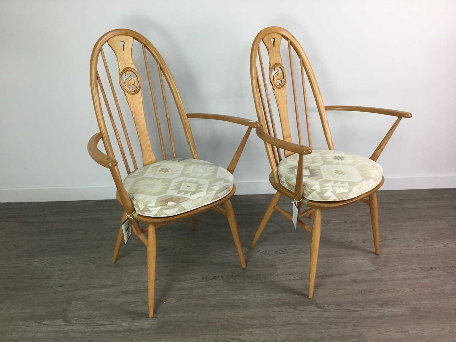 Lot 90 - A SET OF FOUR ERCOL SWAN BACK DINING CHAIRS