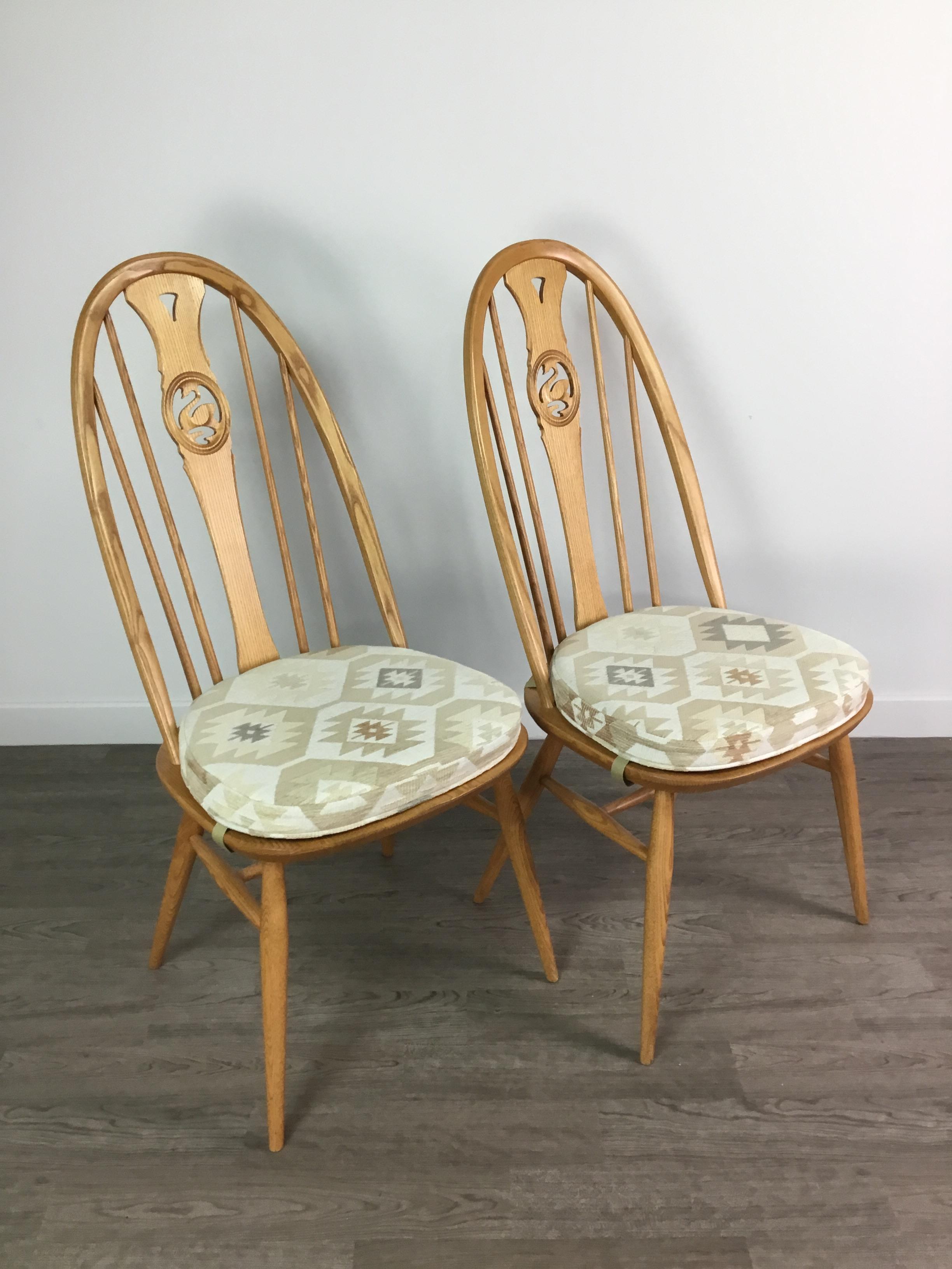 Lot 90 A SET OF FOUR ERCOL SWAN BACK DINING CHAIRS