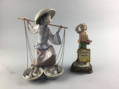 Lot 149 - A LLADRO FIGURE OF A WOMAN CARRYING FISH AND AN ITALIAN FIGURE OF A BOY EATING FRUIT