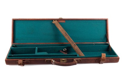 Lot 211 - AN EARLY 20TH CENTURY BROWN LEATHER GUN CASE ALONG WITH A SHOTGUN CLEANING ROD