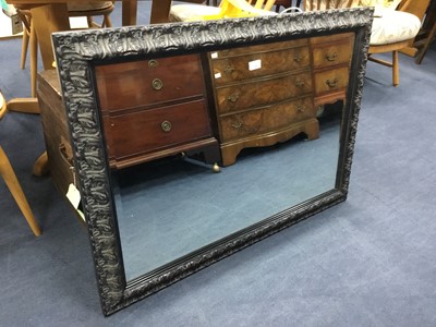 Lot 276 - A MODERN RECTANGULAR WALL MIRROR IN AN EBONISED CARVED FRAME