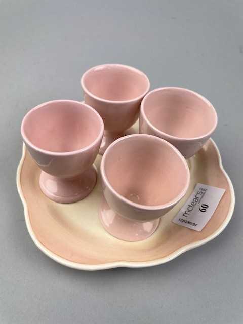 Lot 60 - A SUSIE COOPER EGG CUP STAND AND FOUR OTHER EGG CUPS