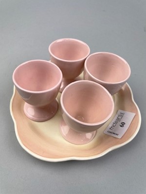 Lot 60 - A SUSIE COOPER EGG CUP STAND AND FOUR OTHER EGG CUPS