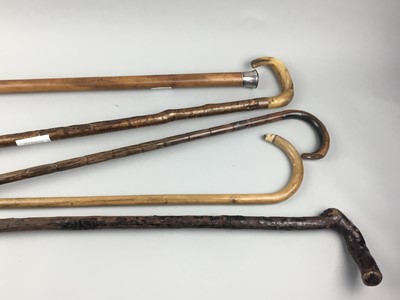 Lot 202 - A COLLECTION OF VINTAGE WALKING CANES AND AN OIL ON CANVAS BY F. OKEBNI