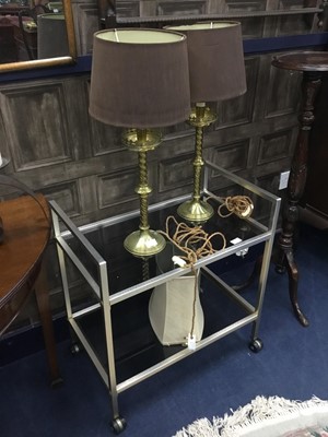 Lot 199 - A HANDMADE SCROLLING METAL CANDLE STAND, BRASS TABLE LAMPS AND A TROLLEY