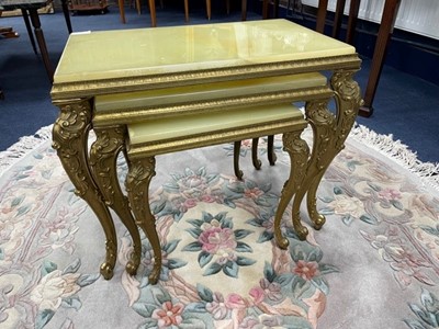 Lot 522 - A NEST OF THREE ONYX AND BRASS OCCASIONAL TABLES