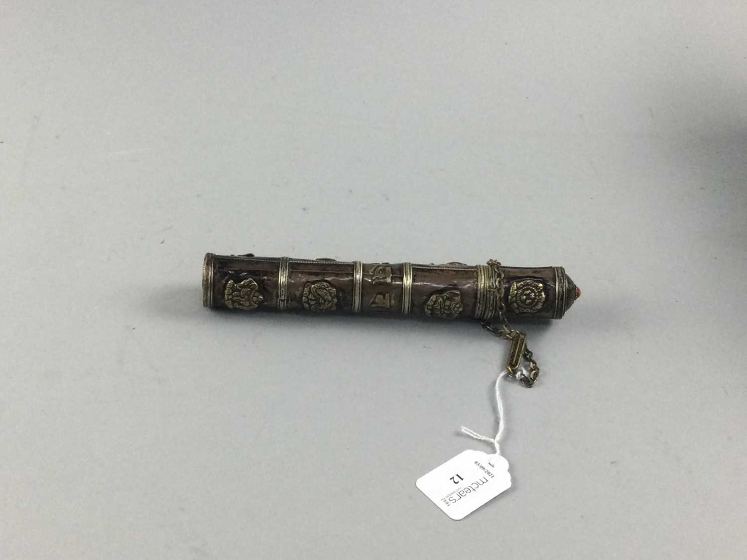 Lot 221 - AN EASTERN COPPER AND BRASS SCROLL HOLDER