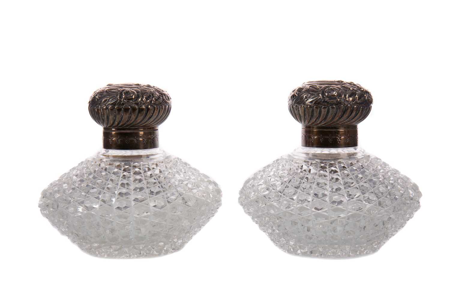 Lot 491 - A PAIR OF VICTORIAN SILVER MOUNTED CUT GLASS SCENT BOTTLES
