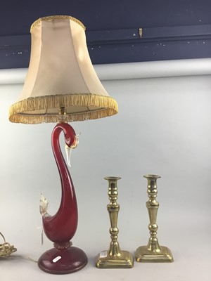 Lot 142 - AN ITALIAN RED GLASS TABLE LAMP AS SWAN AND A PAIR OF BRASS CANDLESTICKS