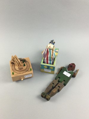 Lot 75 - A WOODEN MUSICAL TOY TRAIN ON TRACK ALONG WITH TWO OTHER TOYS