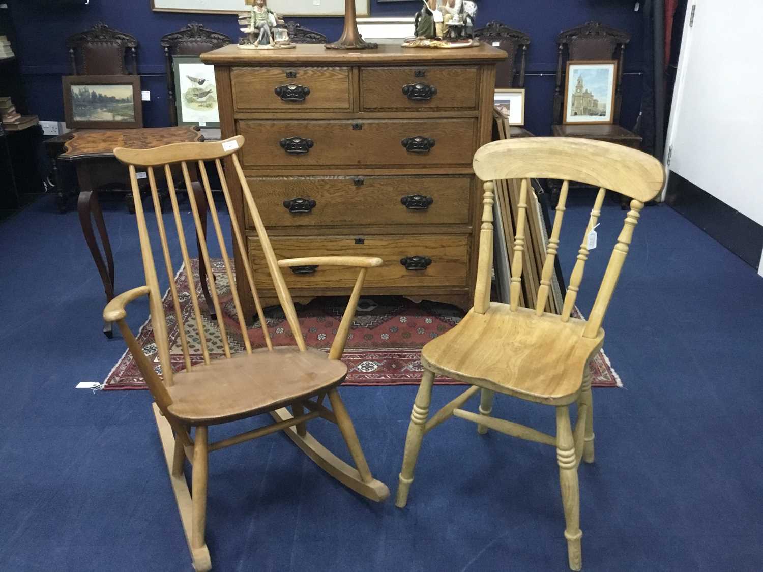 Lot 97 - AN ERCOL OAK ROCKING ARMCHAIR AND A SPINDLE BACK KITCHEN CHAIR