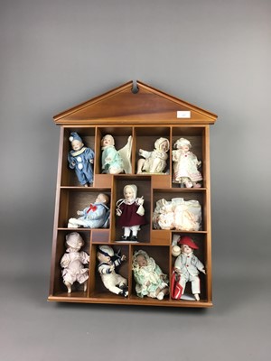Lot 127 - A COLLECTION OF MINIATURE PORCELAIN DOLLS IN A DISPLAY CABINET