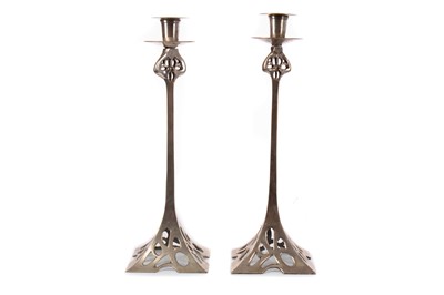 Lot 859 - A PAIR OF SILVER PLATED BRASS SECESSIONIST CANDLESTICKS