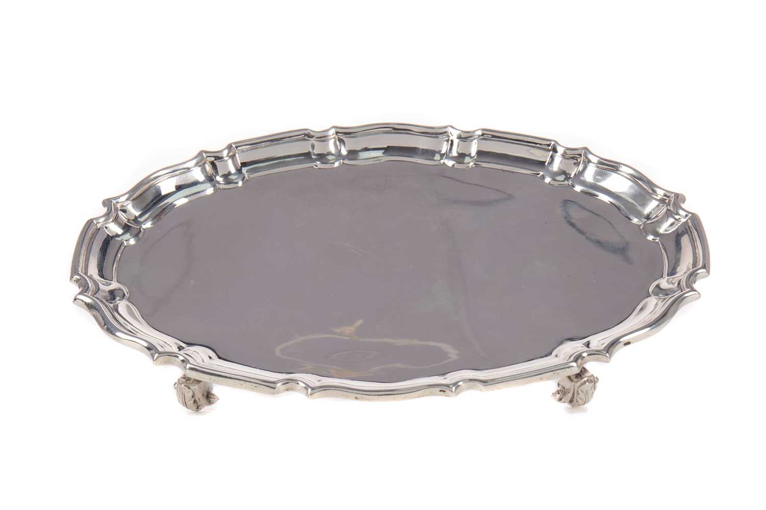 Lot 570 - A GEORGE V SILVER STAND OF SHAPED OUTLINE