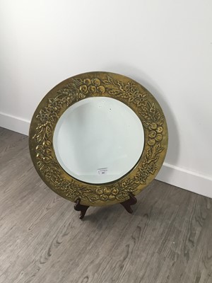 Lot 482 - A HAMMERED BRASS MIRROR